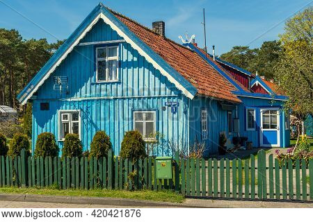 Nida, Lithuania - May 10 2021: Beautiful Old Lithuanian Traditional Wooden Light Blue House Of The C