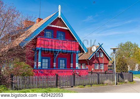 Nida, Lithuania - May 10 2021: Beautiful Old Lithuanian Traditional Wooden Red House Of The Curonian