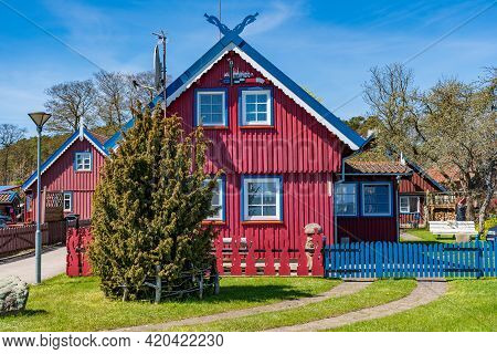 Nida, Lithuania - May 10 2021: Beautiful Old Lithuanian Traditional Wooden Red House Of The Curonian