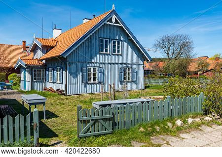 Nida, Lithuania - May 10 2021: Beautiful Old Lithuanian Traditional Wooden Light Blue House Of The C
