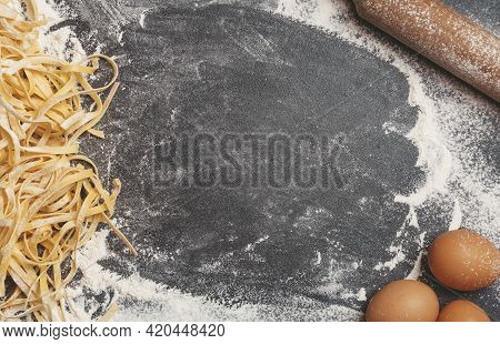 Making Homemade Background Pasta. Kitchen Table Background With Flour, Pasta, Rolling Pin And Eggs F
