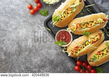 Homemade Hot Dog Sandwiches. Hot Dogs With Mustard And Letuce Toping On Dark Background