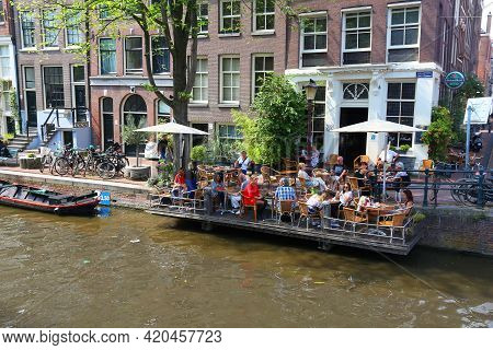 Amsterdam, Netherlands - July 7, 2017: People Visit Summer Cafe At Egelantiers Gracht In Amsterdam, 