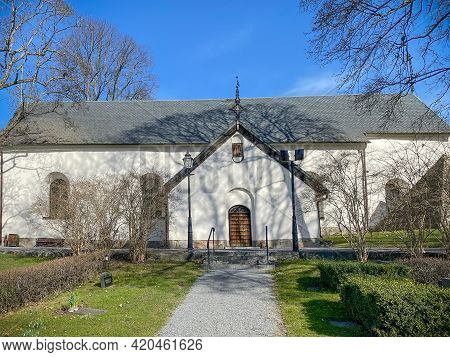 Barkarby, Sweden - April 2, 2021: Outdoor Front View Of The Christian Church Järfälla Kyrka With Sur