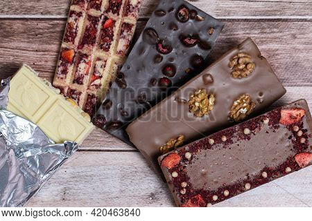Different Kinds Fof Chocolate Bars On Vintage Wooden Background. Dark One, Milk And White, With Piec