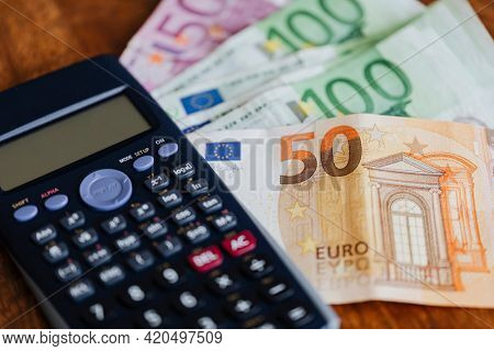 Calculator and Euro banknotes on a table
