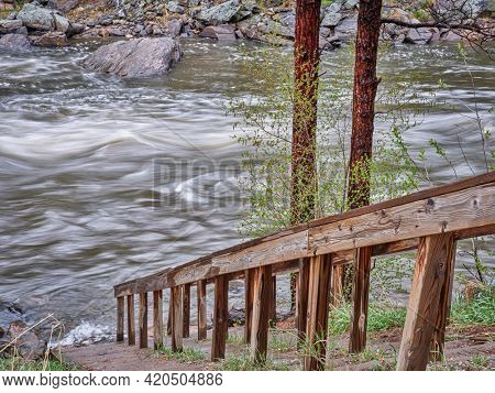 river access for whitewater paddlers - Poudre River in the canyon above Fort Collins, Colorado, spring scenery with high water flow