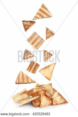 Delicious Crispy Pita Chips Falling Into Heap On White Background