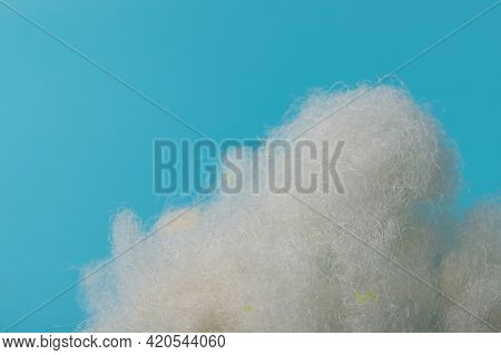 White Air Sintepon. Type Pillow Material. Sintepon Filler On Blue Background, Soft Texture