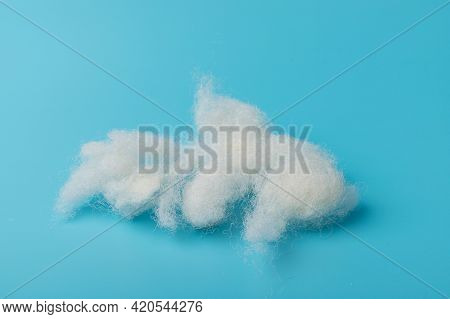 White Air Sintepon. Type Pillow Material. Sintepon Filler On Blue Background, Soft Texture