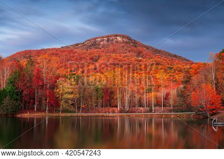 Yonah Mountain, Georgia, USA from Chambers Lake in autumn at dusk.