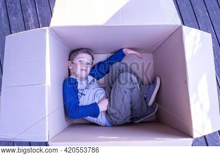 Cute European Boy Lying In A Cardboard Box, Homeless Life, Package