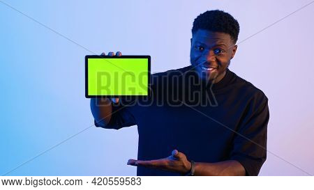 Man Showing A Tablet With A Green Screen At The Camera - Hand Gestures. High Quality Photo