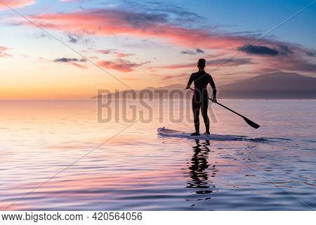 Adventurous Girl On A Paddle Board Is Paddeling In The Pacific West Coast Ocean. Sunset Sky Art Rend