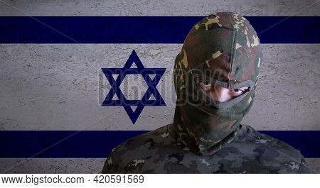 Militant Israel Angry Soldier With Green Camouflage Balaclava On Israeli Flag. Military Zionist Figh