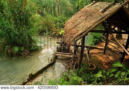 Wooden Water Turbine At Outdoor In Forest Of Tat Kuang Si Waterfalls Or Kuang Xi Falls For Laotian P
