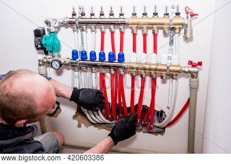 Pipefitter Install System Of Underfloor Heating System At Home