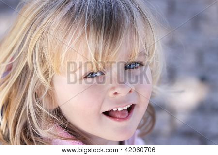 Portrait Of A Little Girl With Blue Eyes