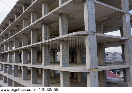 Aerial View Of Concrete Frame Of Tall Apartment Building Under Construction In A City.