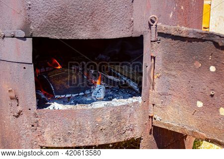 Fire Flames Are Igniting And Burning, Blazing In The Old Rusty Firebox.