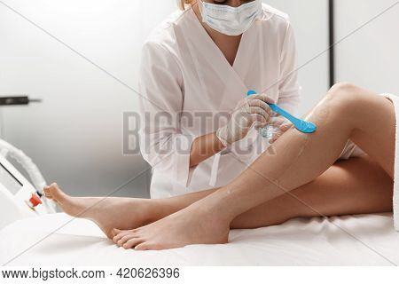 Laser Hair Removal. Beautician Smear Cooling Soothing Gel For Beauty Epilation On Legs. Cosmetology 