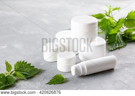 Natural Spa, Herbal Cosmetics With Nettle In White Bottles. Cosmetik Or Spa Concept, Copy Space