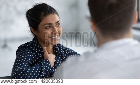 Happy Indian Female Employee Discussing Project On Corporate Briefing