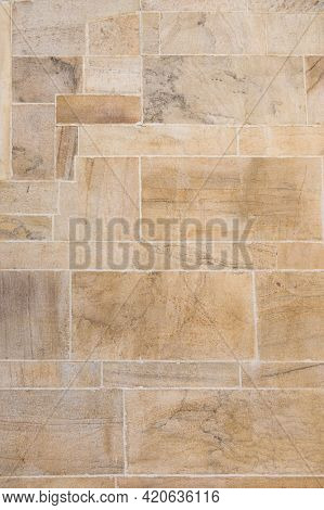 Close up of weathered stone cladding of a wall from old architecture. Grunge floor made with sand stone.