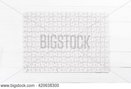 Completed white rectangular jigsaw puzzle