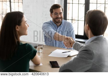 Happy Employee Candidate Shaking Hands With Employer Or Recruiter