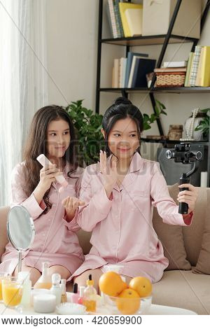 Pretty Smiling Female Friends Shooting Video On Skincare And Beauty For Their Channel Together
