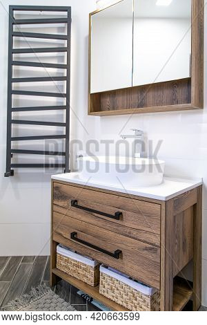 Light Bathroom Interior With Wooden Furniture In A Minimalist Style.