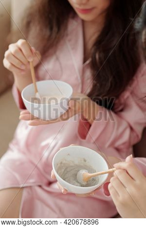 Close-up Image Of Young Women Mixing Powdered Clay And Water In Bowl To Applying It As Face Mask Lat