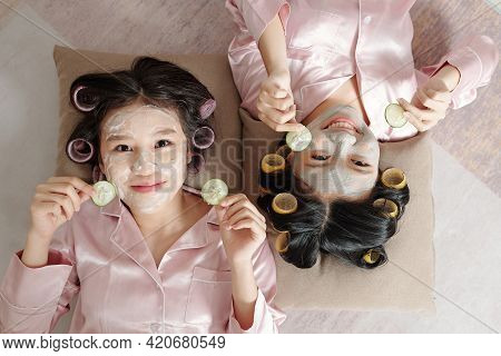Two Young Women Pajamas Having Fun At Spa Party Together At Home