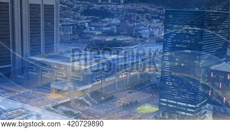 Composition of digital light trails over cityscape. global data processing and digital interface concept digitally generated image.