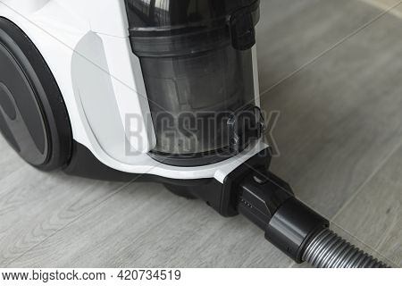 Bagless Cyclone Vacuum Cleaner On A Grey Tile. Electrical Apparatus That By Means Of Suction Collect