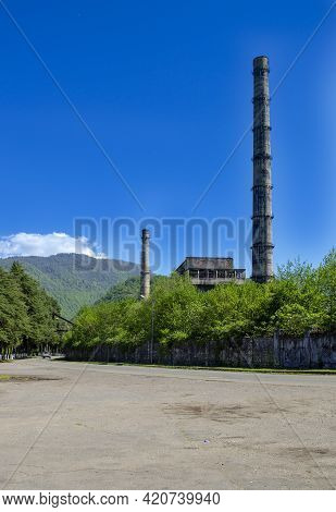 Overgrown Ruins Of Industrial Building. Abandoned, Destroyed By War Power Plant In Tkvarcheli (tquar