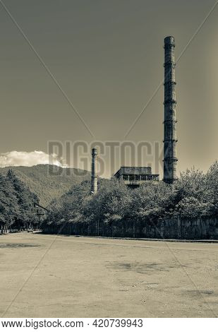 Overgrown Ruins Of Industrial Building. Abandoned, Destroyed By War Power Plant In Tkvarcheli (tquar