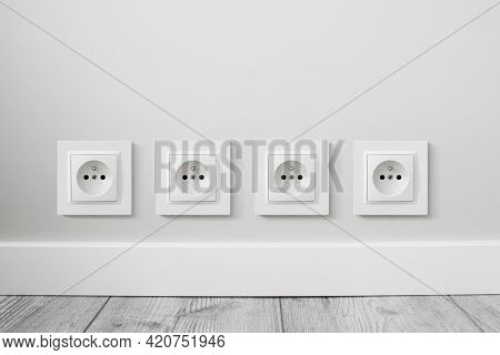 New Electrical Socket Isolated On Gray Wall. Renovated Studio Apartment Power Supply Background. Gra