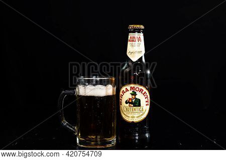 Can Of Birra Morreti Beer And Beer Glass On Dark Background. Illustrative Editorial Photo Shot In Bu