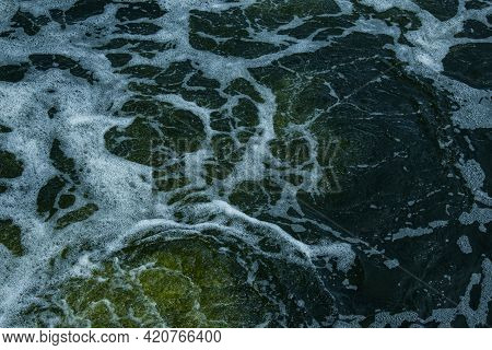 The Texture Of Water On The Surface Of A Small Waterfall In The Ukrainian Steppe Close-up. Tokovsky