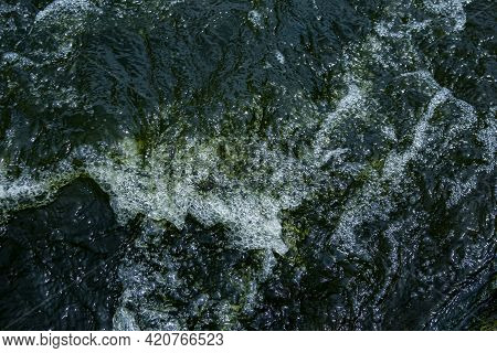 The Texture Of Water On The Surface Of A Small Waterfall In The Ukrainian Steppe Close-up. Tokovsky