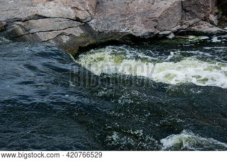 The Texture Of Water On The Surface Of A Small Waterfall In The Ukrainian Steppe Close-up. Tokovsky