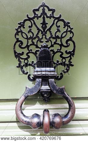 European Vintage Old Metal Wrought Iron Door Knocker. Design Detail. Paris.