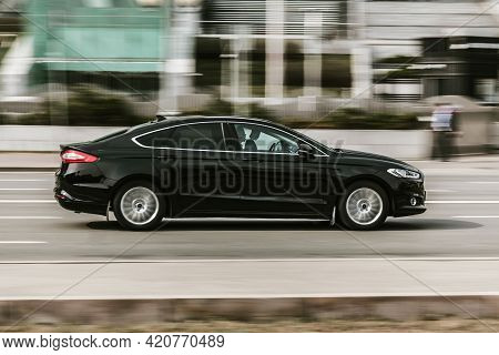 Ford Mondeo Fourth Generation Car Moving On The Street. Black Ford Fusion, Codenamed Cd391 Rushing O