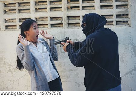 Thief Armed Man Rob Woman By Gun On Street So Scared Shocked Face. Frightened Asian Woman Was Rob Ag
