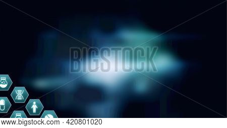 Composition of network of medical icons on hexagons over glowing blue background. global science, medicine and research concept digitally generated image.