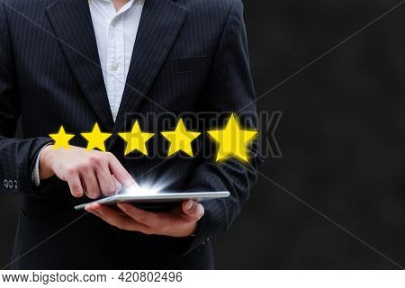5 Star Rating. Business Man Customer Hand Touching On Mobile Tablet With Five Star Button To Review 