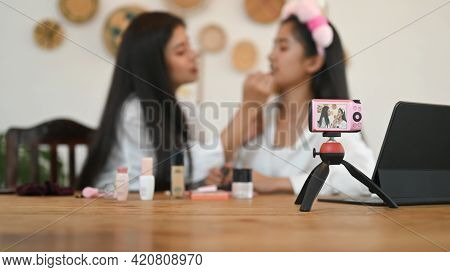 Selective Focus Camera And Women Are Showing How To Make Up Via Online Video At The Dressing Table.