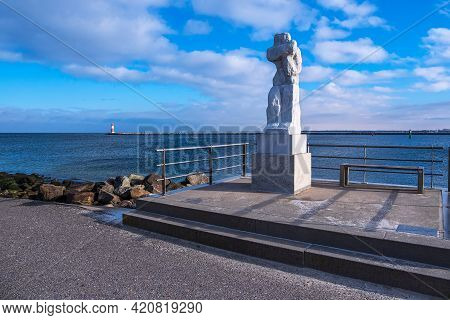 Skulpture Great Standing Woman On The Mole At The Baltic Sea Coast In Warnemuende, Germany.